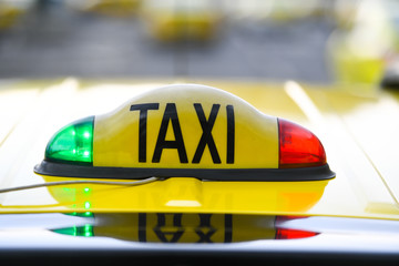 Taxi sign with red and green lights on the roof