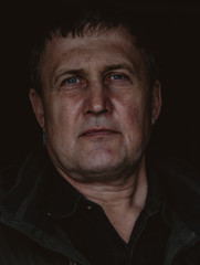 Obraz premium Portrait of mature handsome man with gray hair. Middle age brutal man on black background closeup photo