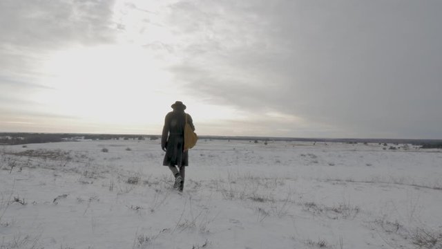 traveler man walking in the winter north field 