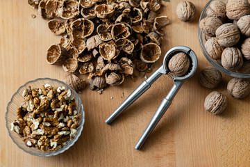 walnuts and nutcracker on wooden background