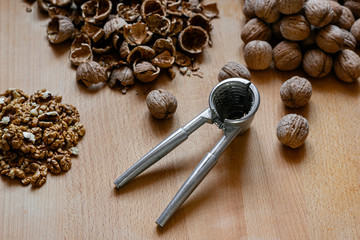 walnuts and nutcracker on wooden background