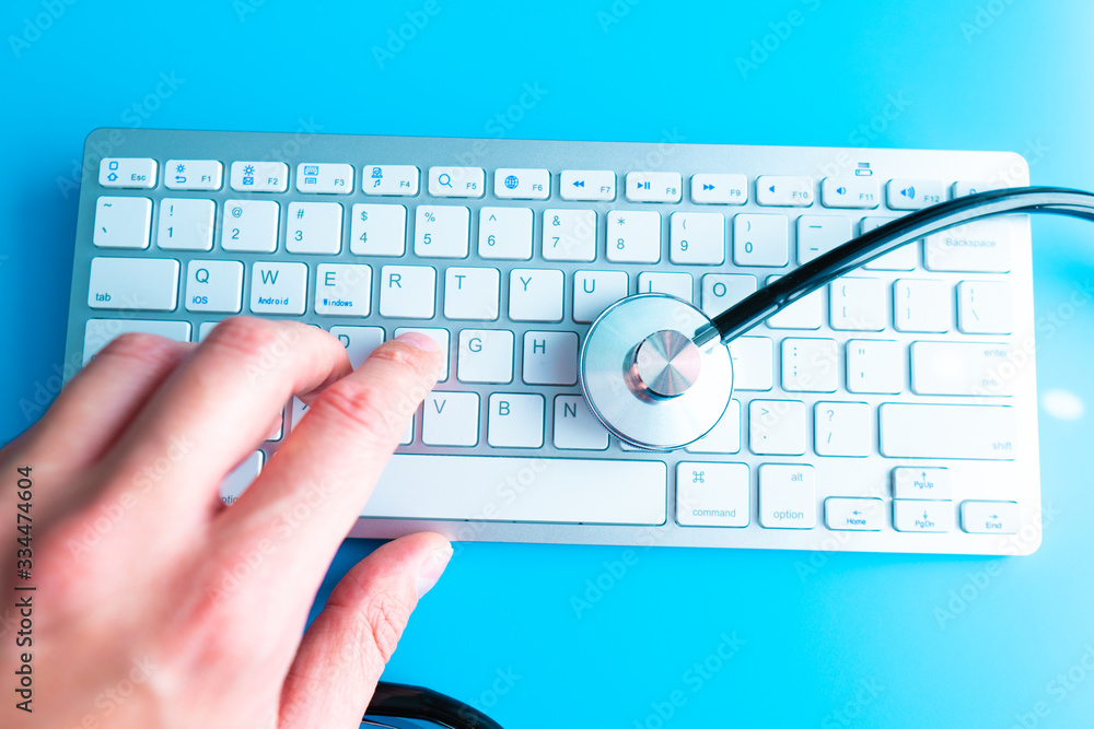 Aufkleber computer system health or auditing - stethoscope over a computer keyboard toned in blue