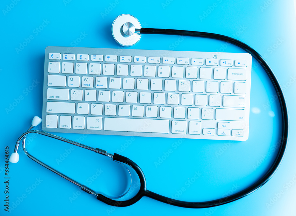 Poster computer system health or auditing - stethoscope over a computer keyboard toned in blue