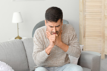 Coughing young man at home