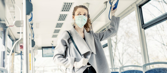 Woman wearing surgical protective mask in a public transportation