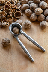 walnuts and nutcracker on wooden background