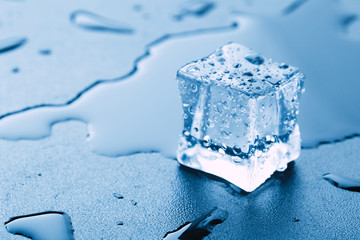 Pyramid of beautiful thawed ice cubes with drops of water