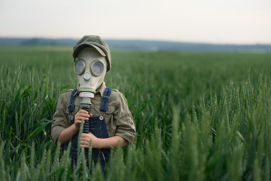 The child in the gas mask.  Concept of environment pollution and  natural disaster. Coronovirus epidemic.
