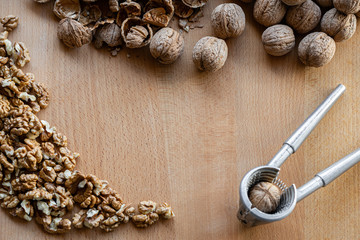 walnuts and nutcracker on wooden background copy space