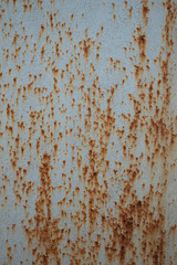 Dirty, painted metal surface with rust.
