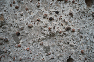 Light concrete surface with black bulges