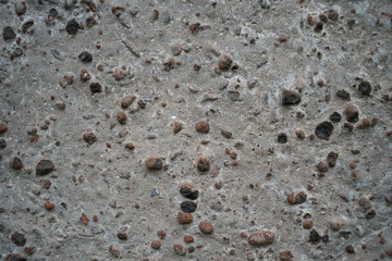 Light concrete surface with black bulges