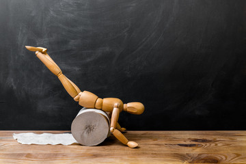 Wooden man carries a roll of toilet paper. Concept of the problem with digestion.