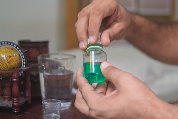 sick man taking a medicine - bottle