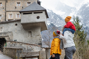 Obraz na płótnie Canvas Family with children taking a walk near an ancient castle in Austria