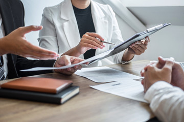 Employer reading a resume with talking during about profile of candidate