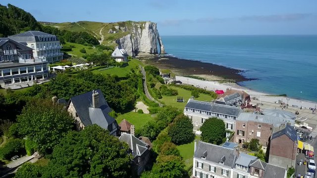 Etretat, France - aerial view of the beautiful coastline and alabaster cliff bay with a shore and ocean during sunny day