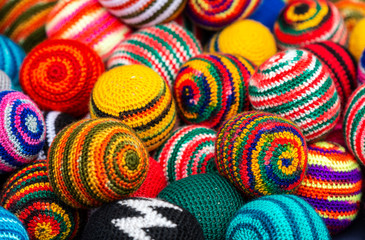 Side view of colorful fabric balls of wool on the Andean craft market of Otavalo, north of Quito, Ecuador.