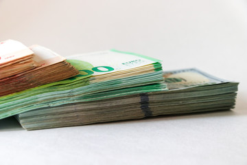 American 100-dollar bills, a bundle of euros and a bundle of ruble bills. Savings, planning, forecasts.