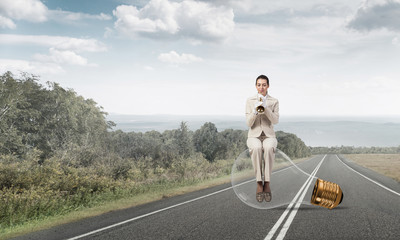 Beautiful woman playing trumpet brass on road