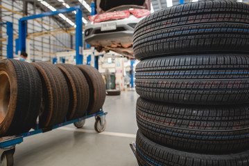 Sell tires at a tire store New tires are changing, comparing old tires with new tires.