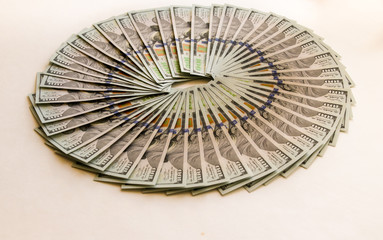 A fan of hundred-dollar bills isolated on a white background. Finance, investment, and Economics.