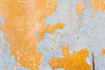 Texture of old concrete wall. Old shabby concrete wall covered with exfoliant orange paint . High resolution abstract texture for background, poster, collage in the vintage or grunge style.