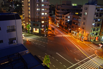 tokyo junction at nighttime next to park and shop