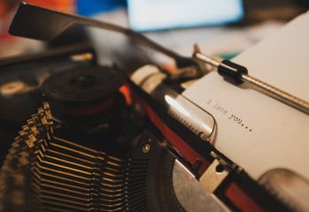 Fototapeta na wymiar I Love You ago typed on old vintage typewriter machine. Retro style.
