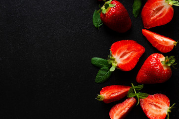  fresh strawberries on a dark background