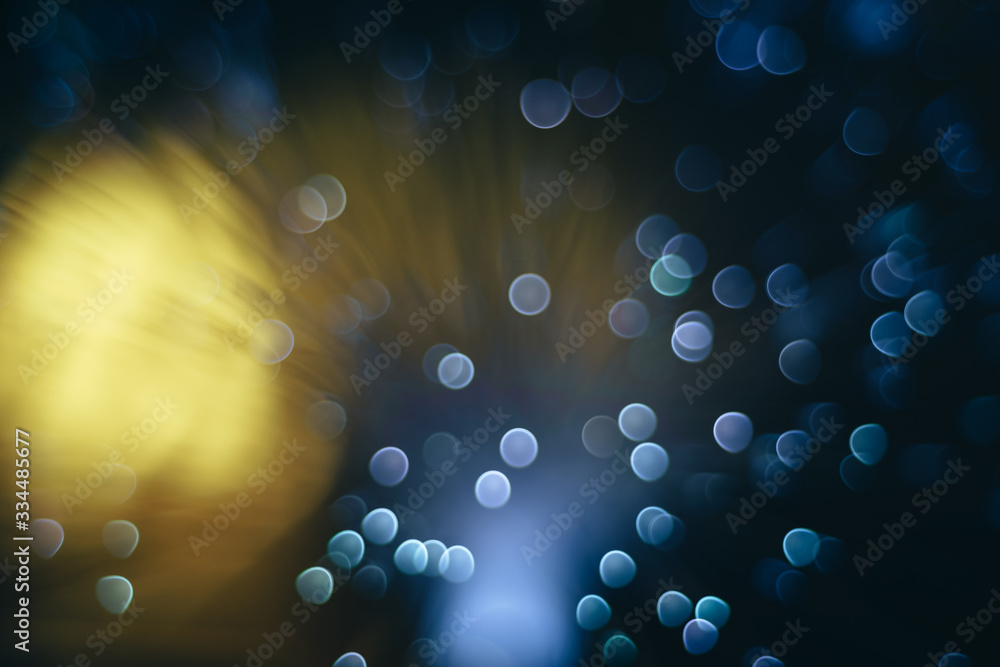 Poster beautiful abstract blue bokeh collapse background on a dark.