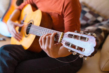 Unrecognizable caucasian female learning how to play an instrument. Leisure and music at home...