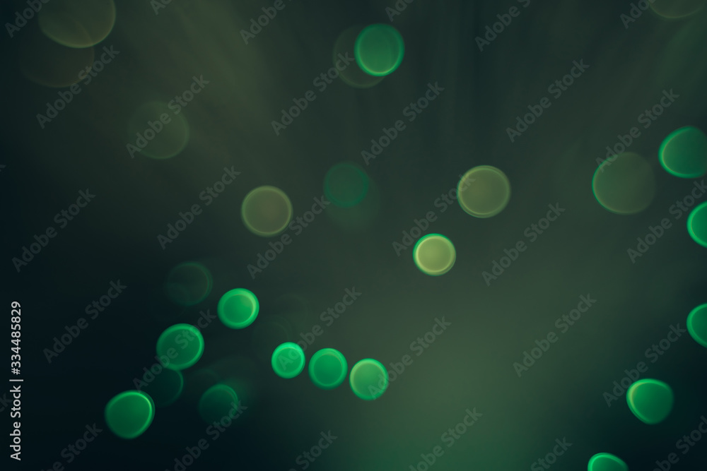 Poster beautiful abstract green bokeh collapse background on a dark.