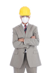 A businessman architect in a light tan suit wearing a hard had and protective face mask.