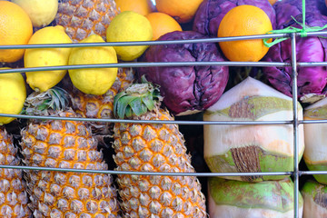 Colourful tropical fruits stacked together, including coconut, pineapple, lemon. Concept of fresh tropical fruits.