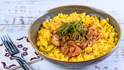 A traditional Moroccan dish called Chicken Tajine featuring Saffron, Honey, Almonds, Dates, Couscous and Labneh