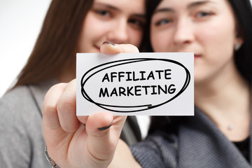 Business, technology, internet and network concept. Young businessman shows a keyword: Affiliate...