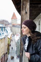 Woman watching down from high passages in Tallinn, Estonia