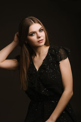 Fashion studio portrait of young beautiful woman on black background