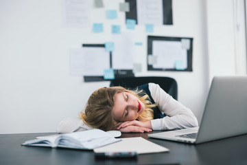 young beautiful businesswoman manager fell asleep tired after hard work day in her modern office, multitasking, work concept