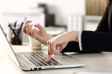 Angry executive hands pressing laptop button at the office