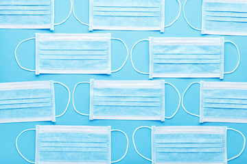 Medical hygienic mask, Face protective masks on blue background.Disposable surgical face mask protective against Coronovirus Covid-19,pollution, virus, flu.Healthcare medical surgical Flat lay pattern
