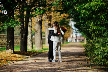 Fototapeta na wymiar Beautiful loving couple spending time together in the park. Valentine's Day celebration