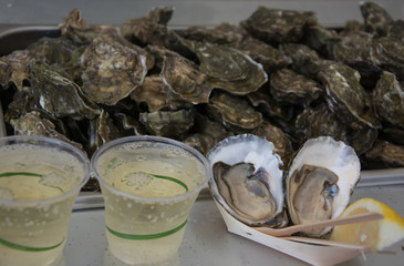 Fresh raw oysters with glass of champagne  and lemon slice, with copy space