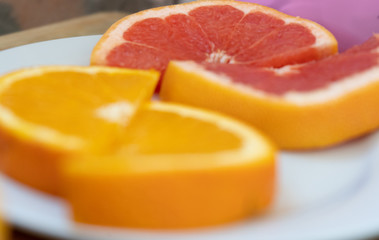 Plakat orange and grapefruit slices on a white surface vitamins in isolation, quarantine