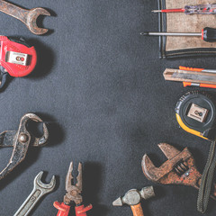 Obraz premium Tools for repair and reconstruction in home conditions lie on a black background