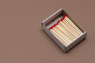 matches in a cardboard box on a craft color background