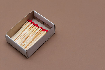 matches in a cardboard box on a craft color background