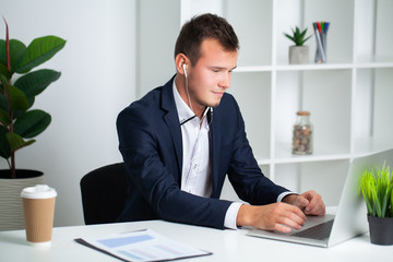 Fototapeta premium Solid businessman in a jacket works in office of the company