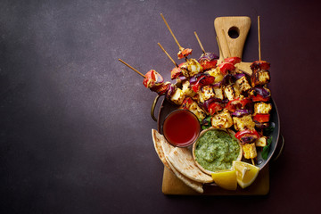 Paneer tikka starter kebabs with mint chutney and chapati. Traditional indian cuisine, grilled...